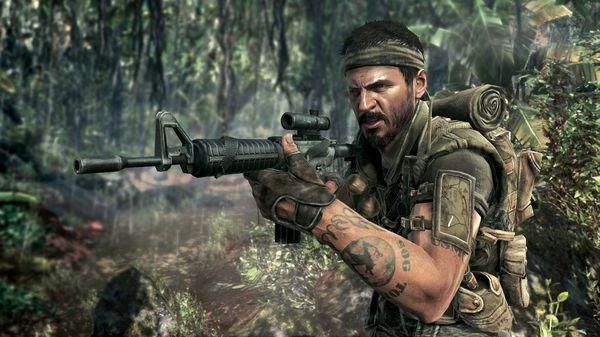 Screenshot from Call of Duty: Black Ops showing a soldier in a jungle setting, aiming a rifle with foliage in the background.