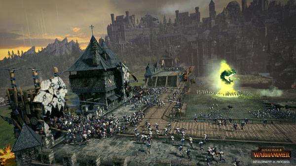 Screenshot from Total War: WARHAMMER showing a large army advancing towards a fortified city with a glowing portal.
