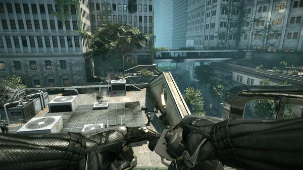 Crysis 2 Remastered screenshot: A player views a rooftop scene with weapons drawn, surrounded by urban buildings and trees.
