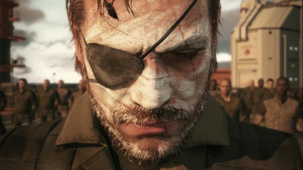 Screenshot from Metal Gear Solid V: The Phantom Pain showing a close-up of a character with an eyepatch and face paint, surrounded by soldiers.