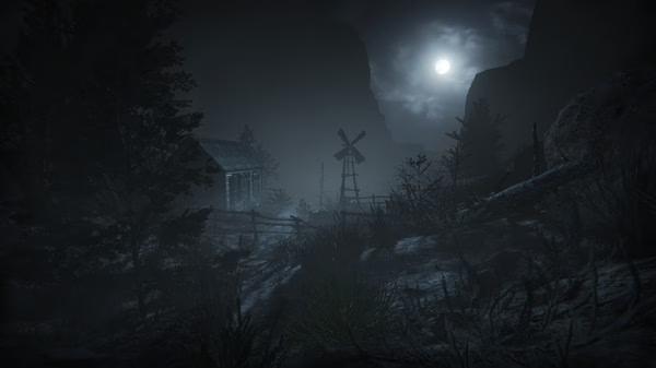 Outlast 2 screenshot: A moonlit landscape with a windmill and cabin surrounded by eerie trees and fog, creating a tense atmosphere.