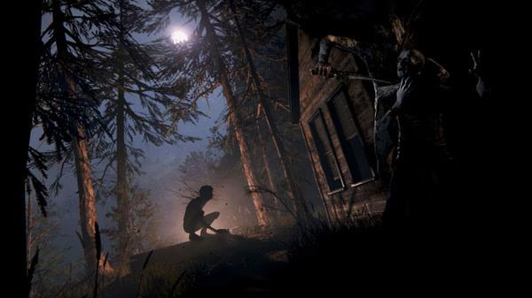 A screenshot from Outlast 2 showing a crouched figure in a dimly lit forest, with a menacing creature near a wooden cabin.
