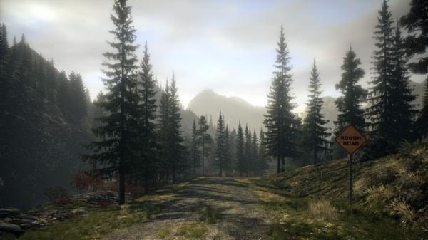 A screenshot from Alan Wake showing a forested mountain road with a "Rough Road" sign under a cloudy sky.