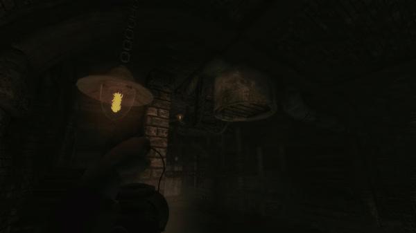 Screenshot from Amnesia: A Machine for Pigs shows a dimly lit industrial tunnel with rusted pipes and a glowing hanging lamp.