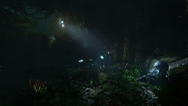 Screenshot from SOMA showing an underwater scene with a diver in a suit sitting amidst glowing sea plants and mysterious lights.