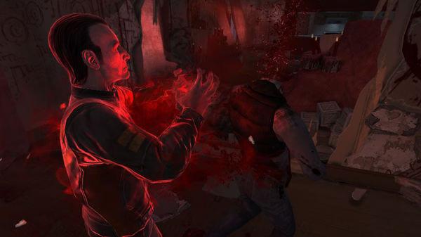 F.E.A.R. 3 screenshot: A glowing red character uses psychic powers to attack an enemy in a dark, chaotic room.