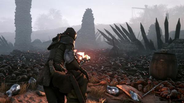 Screenshot from A Plague Tale: Innocence shows a character with a torch navigating a field of debris and rats amid ruins.