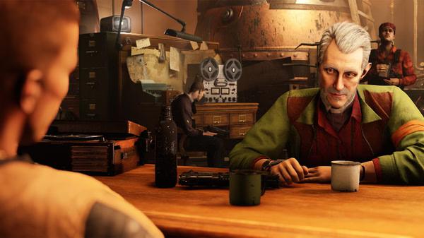 Screenshot from Wolfenstein II: The New Colossus showing characters sitting at a table in a detailed, industrial interior setting.