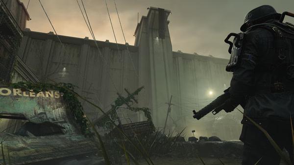 Screenshot from Wolfenstein II: The New Colossus shows a soldier with a gun facing a large, imposing wall in a foggy, abandoned area.