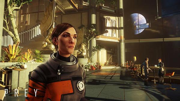 Screenshot from Prey showing a character in a spacesuit inside a futuristic lobby, with Earth visible through large windows.