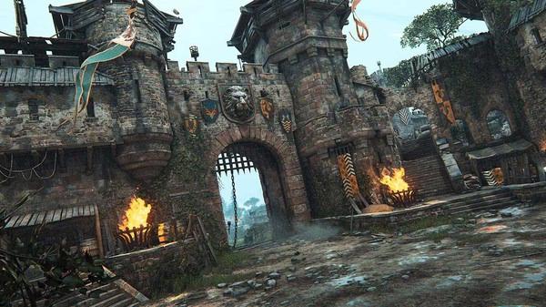 Screenshot of a castle gate in For Honor, with banners, torches, and a medieval stone fortress set against a cloudy sky.