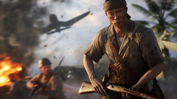 Screenshot of Battlefield V showing a soldier in combat gear holding a rifle, with explosions and aircraft in the background.