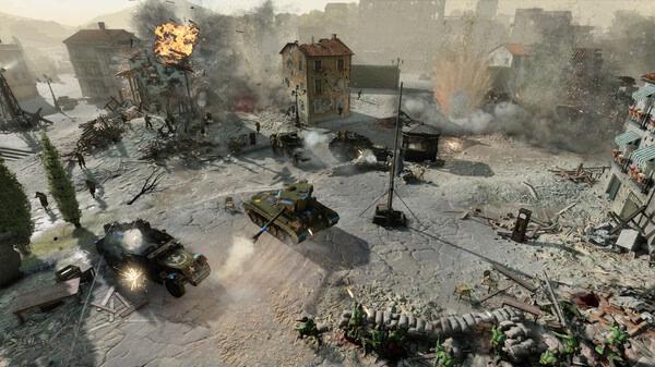 Company of Heroes 3 screenshot showing tanks advancing through a war-torn city, with explosions and debris scattered across the battlefield.