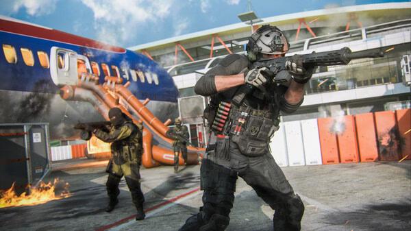 Call of Duty: Modern Warfare III screenshot showing two soldiers in tactical gear amidst a fiery battle near an airplane.