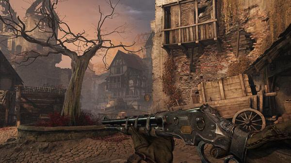 Witchfire screenshot: A player aims a detailed revolver at a rustic village scene with a bare tree and stone buildings under a dusky sky.