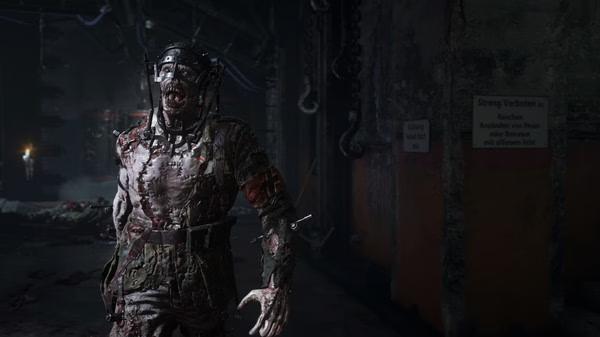 A Call of Duty: WWII screenshot showing a gruesome zombie in a dark, industrial setting with eerie lighting and machinery.