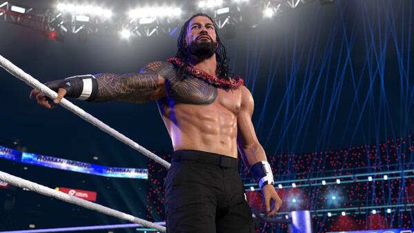 Screenshot from WWE 2K26 showing a muscular wrestler in the ring, adorned with tattoos, under bright stadium lights.
