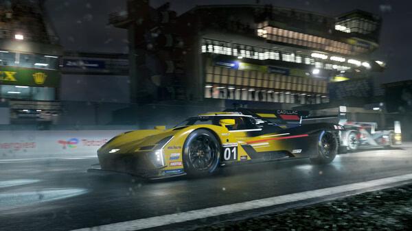 A Forza Motorsport screenshot showing a yellow Cadillac race car speeding on a wet track at night with bright lights in the background.