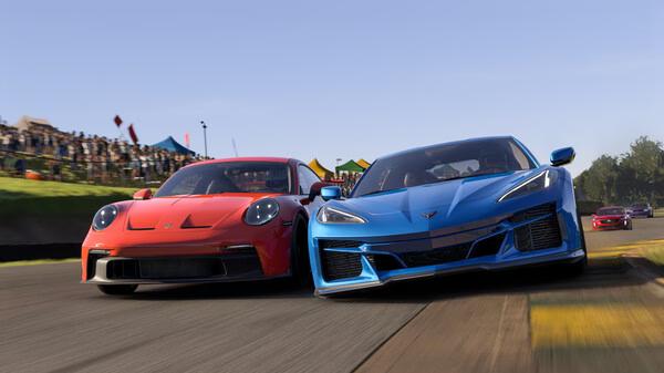 Forza Motorsport screenshot showing a red and a blue sports car racing side by side on a sunny track with a crowd in the background.