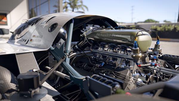 Forza Motorsport screenshot: Close-up view of a detailed Mercedes-Benz engine in a sleek race car, showcasing intricate components and design.