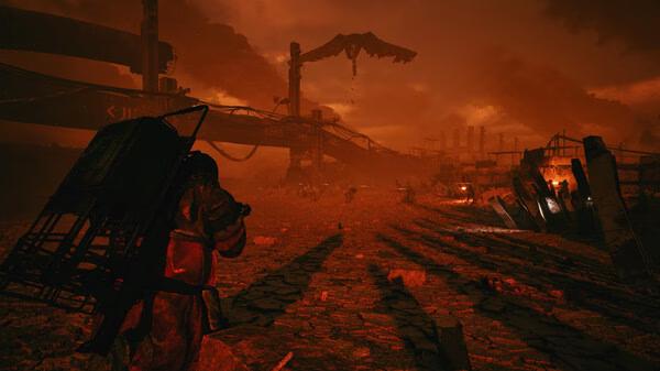 A screenshot from The Forever Winter showing a lone survivor in a desolate, fiery wasteland with crumbling structures.
