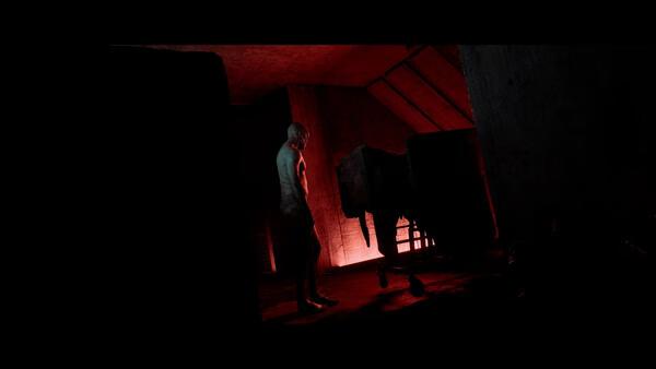 Screenshot from SILENT HILL: Townfall showing a dimly lit room with a figure standing near a cart under red lighting.