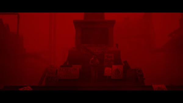 Screenshot from SILENT HILL: Townfall showing a red-tinted scene with a figure near a monument surrounded by protest signs.