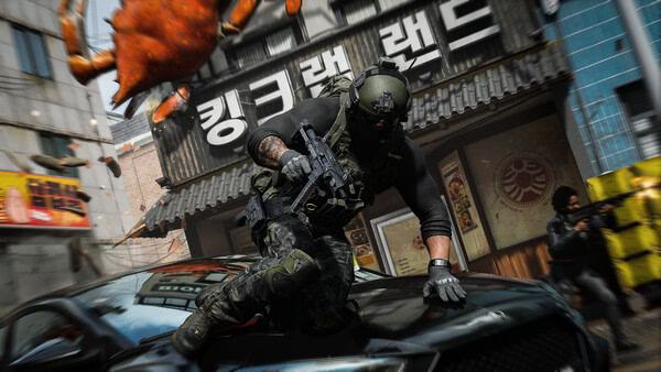 A Call of Duty®: Modern Warfare® 4 screenshot showing a soldier with a rifle sliding over a car in an urban combat zone.