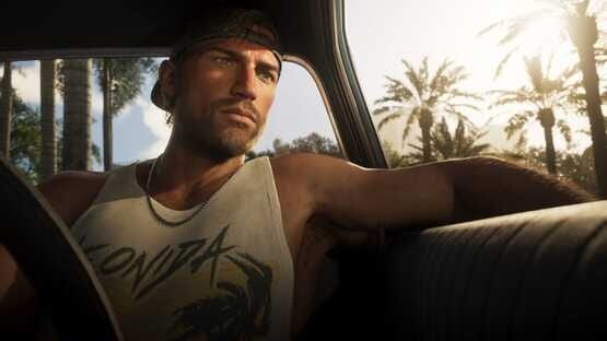 A Grand Theft Auto VI (PlayStation 5) screenshot showing a man in a car with palm trees and sunlight in the background.
