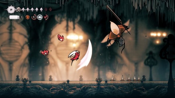 Screenshot from Hollow Knight: Silksong showing the protagonist in combat with a flying enemy in a cavernous setting.