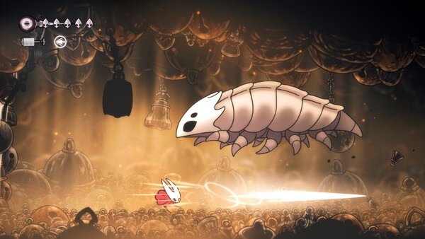 Screenshot of Hollow Knight: Silksong showing a character battling a large, armored insect in a dimly lit cavern.