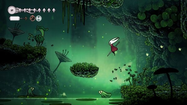 Screenshot from Hollow Knight: Silksong showing the protagonist leaping over lush greenery in a glowing, cavernous environment.