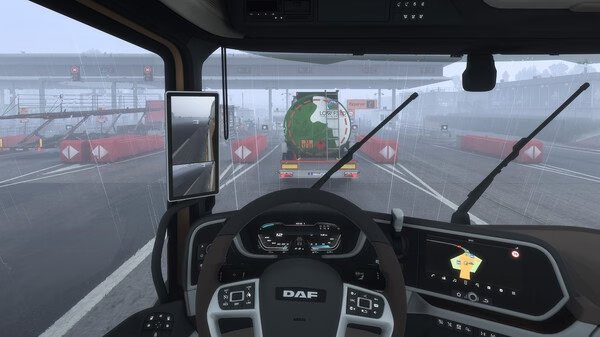 Screenshot from Euro Truck Simulator 2 showing a truck cab interior in rainy weather, approaching a toll booth behind a tanker truck.
