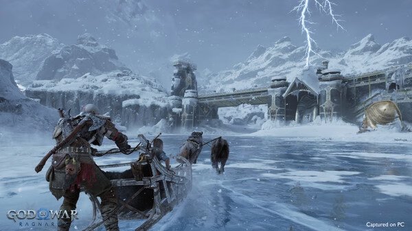 God of War Ragnarök screenshot: Kratos and Atreus navigate a frozen lake in a sled pulled by wolves under a stormy, snowy sky.