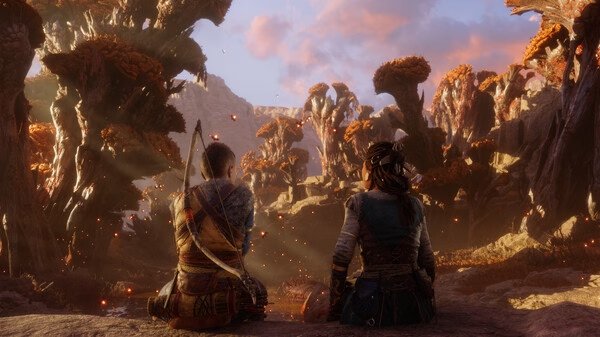 Screenshot from God of War Ragnarök showing two characters sitting in a vibrant, autumnal forest with glowing embers in the air.