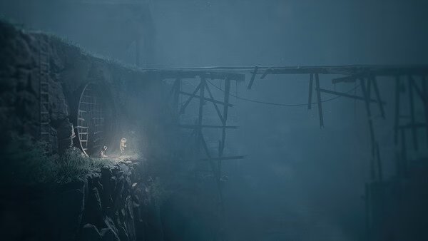 A screenshot from REANIMAL showing two characters near a cave entrance, surrounded by mist and a broken wooden bridge.