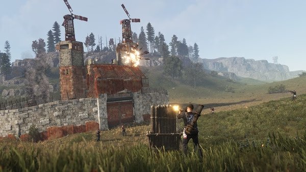 RUST screenshot: A player is defending a stone and metal base under attack, with explosions and gunfire visible in the grassy landscape.