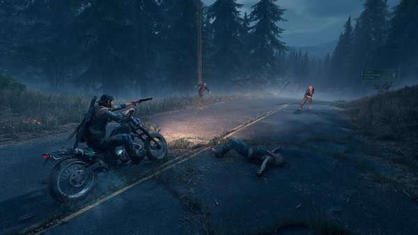 Days Gone screenshot: A biker aims his gun at approaching zombies on a foggy road, surrounded by dense forest.
