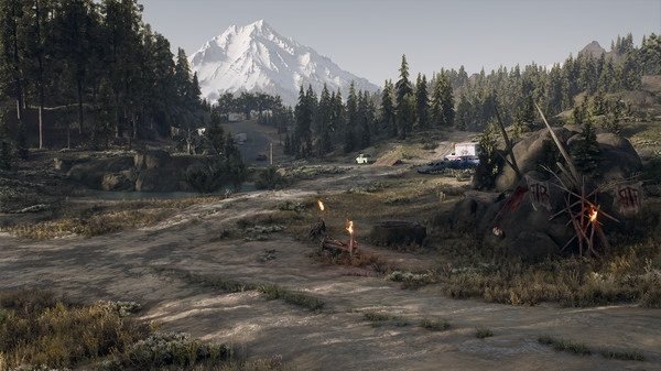A scenic landscape in a Days Gone screenshot shows a mountain, trees, and rustic structures under a clear sky.