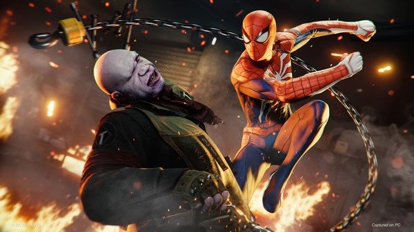 Spider-Man fights a bald villain in fiery surroundings in this action-packed screenshot from Marvel's Spider-Man Remastered.
