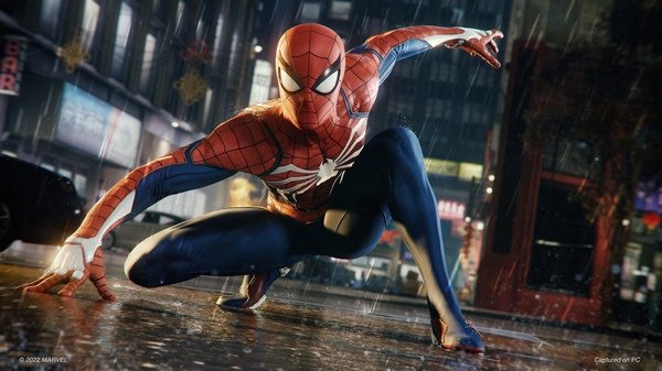Spider-Man crouches in a rainy city street in this screenshot from Marvel's Spider-Man Remastered, showcasing his iconic suit.