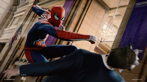 Screenshot from Marvel's Spider-Man Remastered showing Spider-Man swinging a punch at an enemy inside a grand hall.