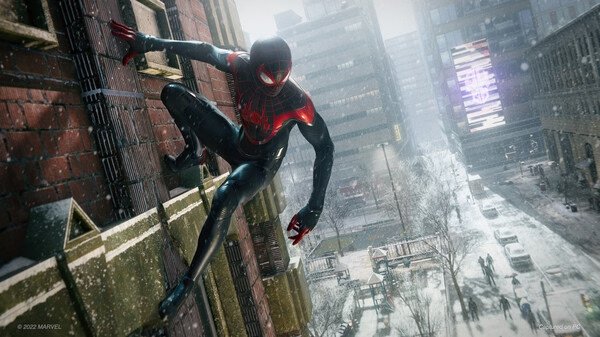 Screenshot from Marvel’s Spider-Man: Miles Morales shows Miles in his red and black suit scaling a snowy city building.