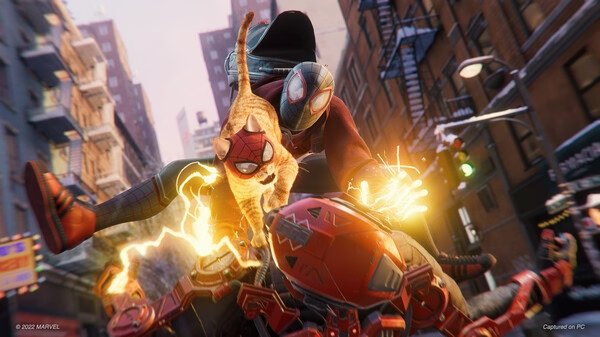 Screenshot from Marvel’s Spider-Man: Miles Morales showing Miles and Spider-Cat mid-action, leaping over a defeated enemy in a city street.