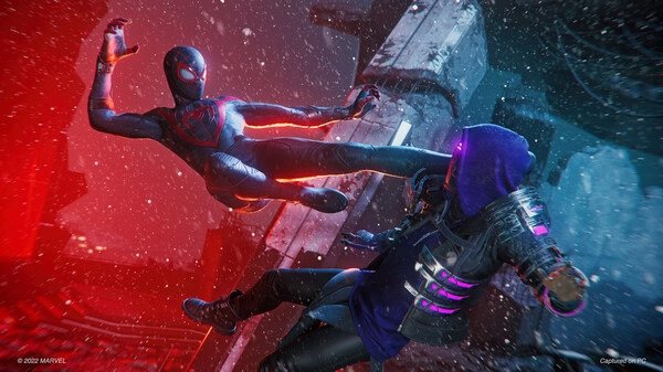 Screenshot from Marvel’s Spider-Man: Miles Morales showing Spider-Man mid-air, delivering a kick against an opponent in a snowy urban setting.