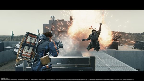 Screenshot from DEATH STRANDING DIRECTOR'S CUT showing Sam Bridges shooting at enemies, with an explosion propelling one into the air.