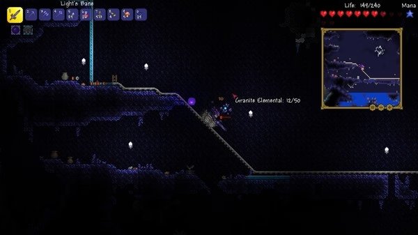 Terraria screenshot showing a player battling a Granite Elemental in a dark underground cave with glowing crystals and a minimap visible.