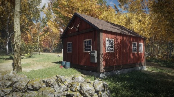 A screenshot from The Hunter Call of the Wild showing a red cabin surrounded by autumn trees and a stone wall in a forest setting.