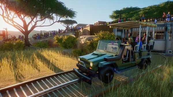 Screenshot from Planet Zoo showing a safari vehicle on a track with passengers, surrounded by trees and a crowd in the background.