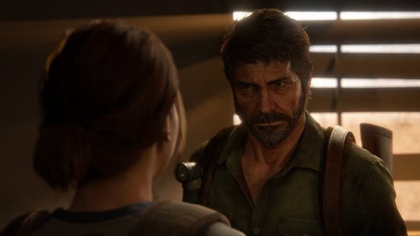 Screenshot from The Last of Us Part II Remastered showing two characters talking in a dimly lit room with sunlight streaming through blinds.